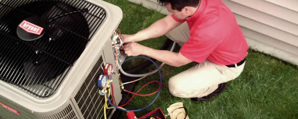 HVAC technician servicing an outdoor air conditioner unit in Miami, FL